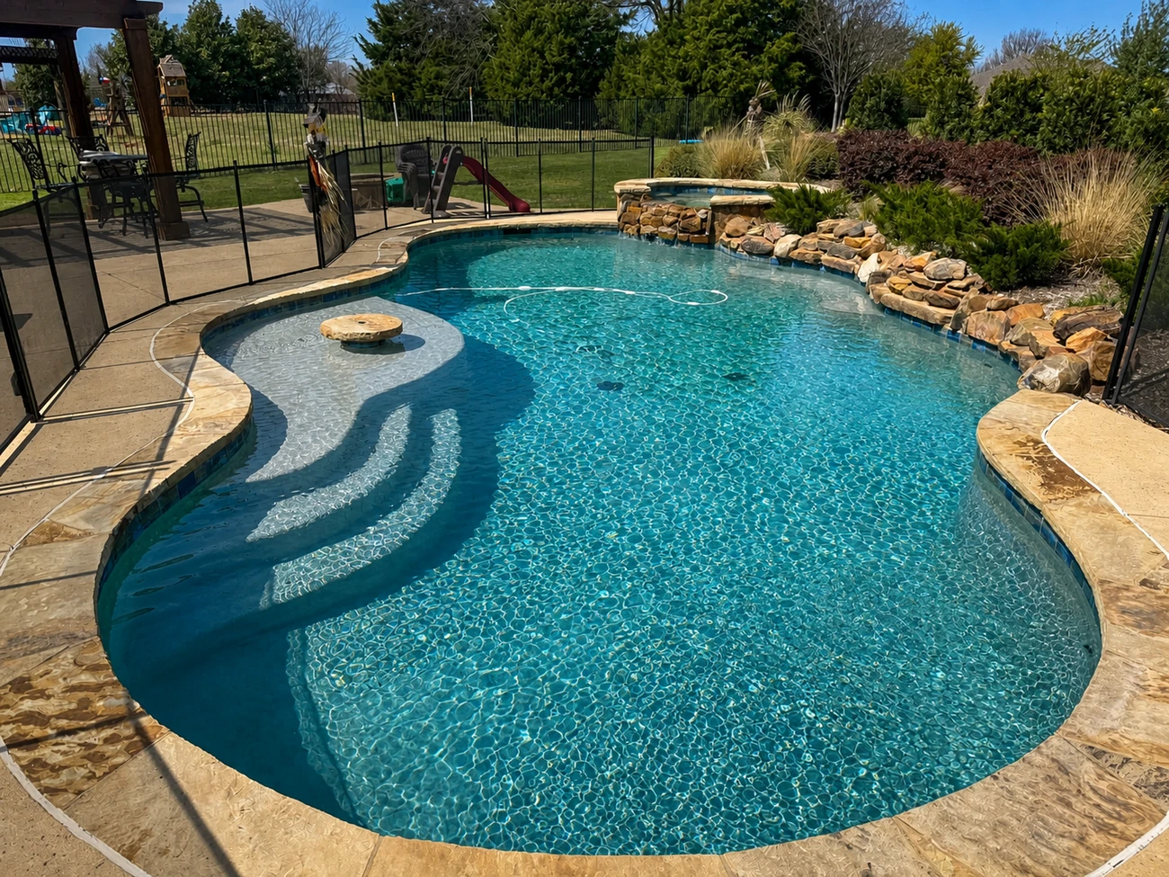 Lagoon-style pool with rock waterfall spa